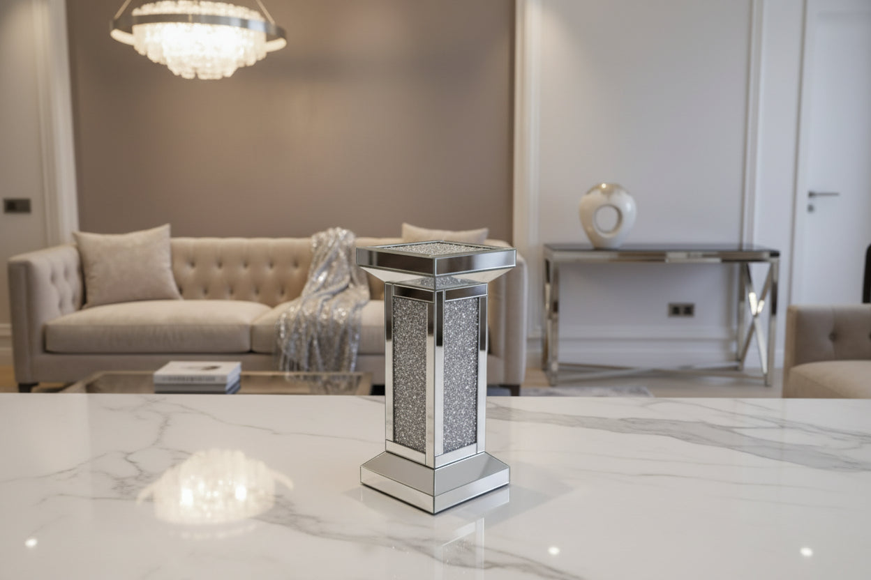 The Crystal Elegance Mirrored Pedestal Table is a small, rectangular table featuring crushed crystal panels and a glittering frame, shown against a plain white background.
