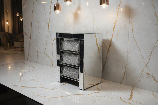 The Roma Bedside 3 Drawers is a small, modern mirrored cabinet with a silver frame and three glittery textured drawers, providing stylish bedroom storage against a plain white background.